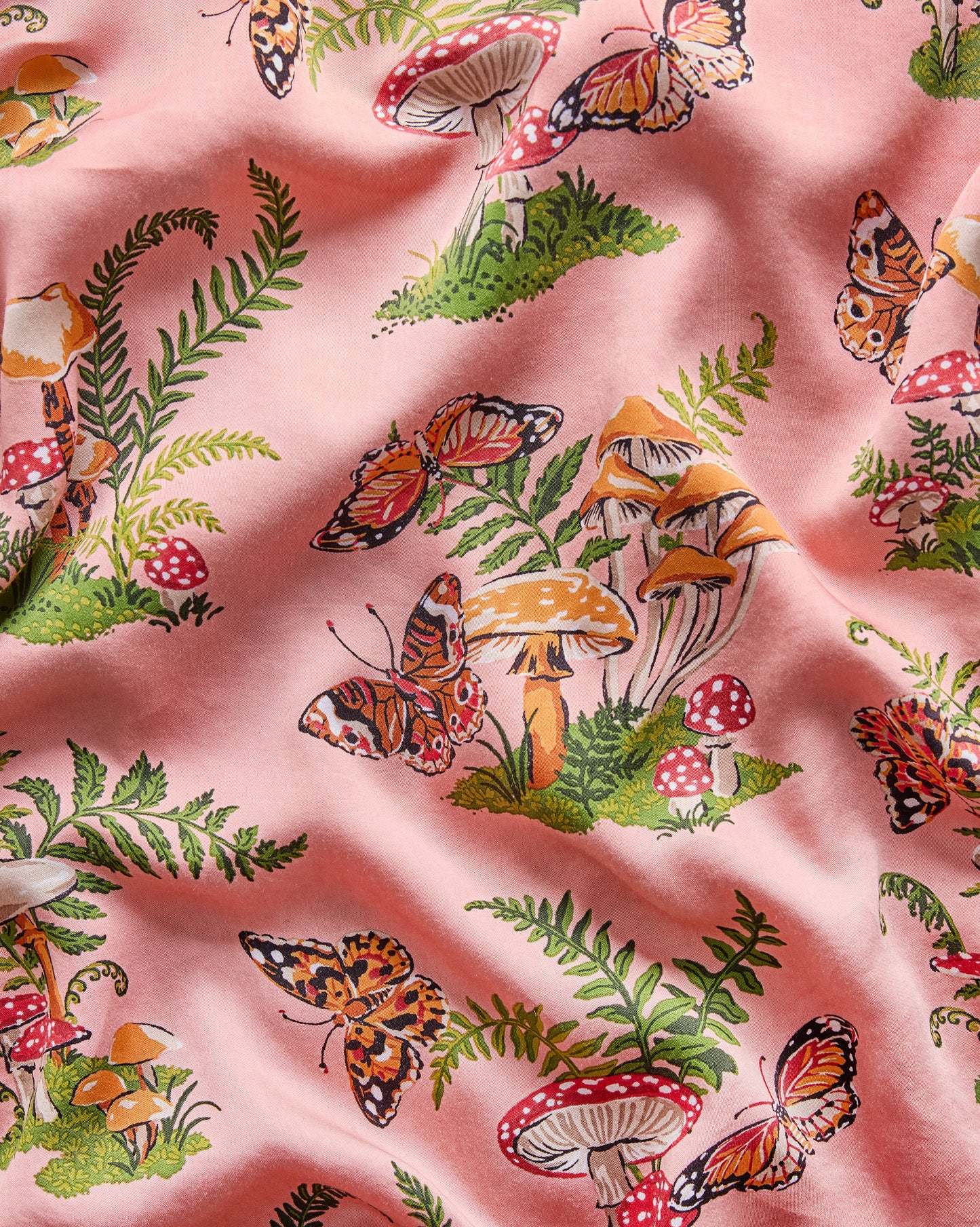 Close-up of the rosewood Butterfly Forager print featuring butterflies, mushrooms, and fern fronds.