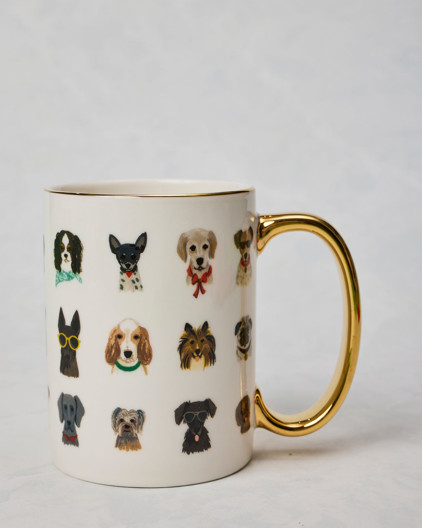 Dog Days porcelain mug shown from the opposite side with a gold handle and rows of illustrated dogs, including dogs wearing sunglasses and bow ties.