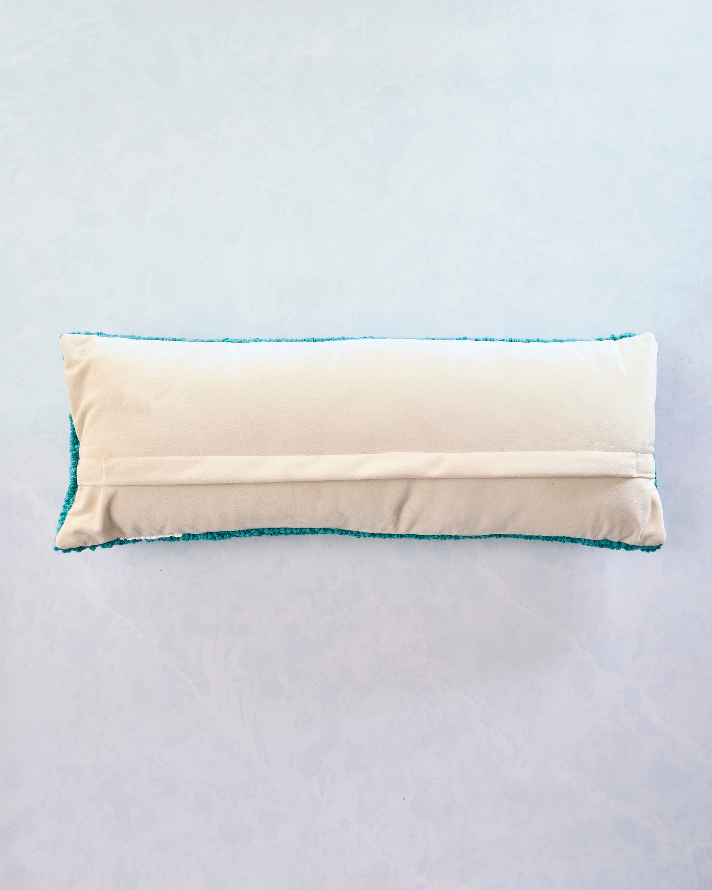 Back view of the trout lumbar pillow showing its beige backing and envelope-style closure.