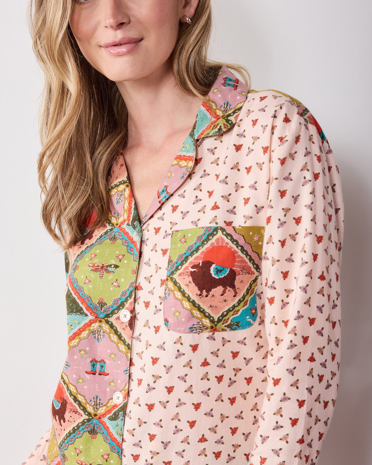 Close view of the patterned long-sleeve button-front top with a contrasting collar and chest pocket.