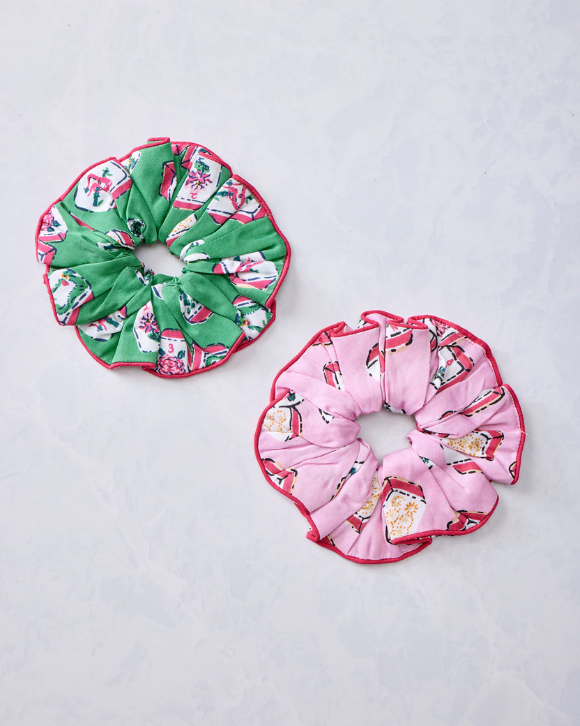 Green and peony pink Mah Jongg-print scrunchies arranged side by side
