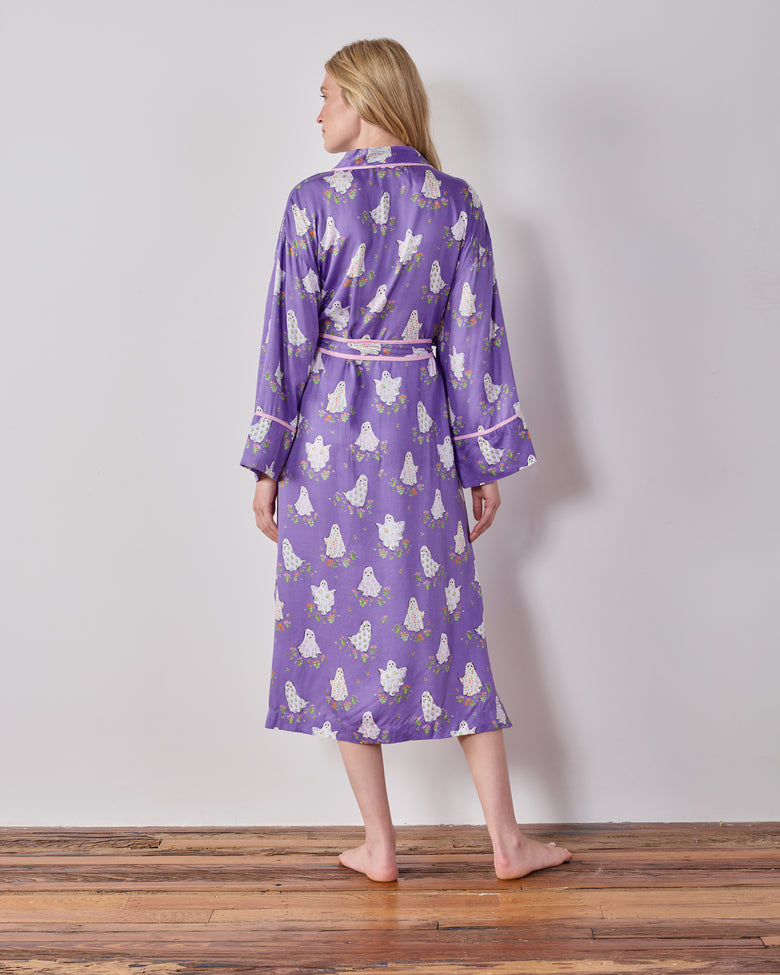 Back view of the purple ghost-and-floral print robe with a belt tied at the waist and pink-trimmed cuffs.