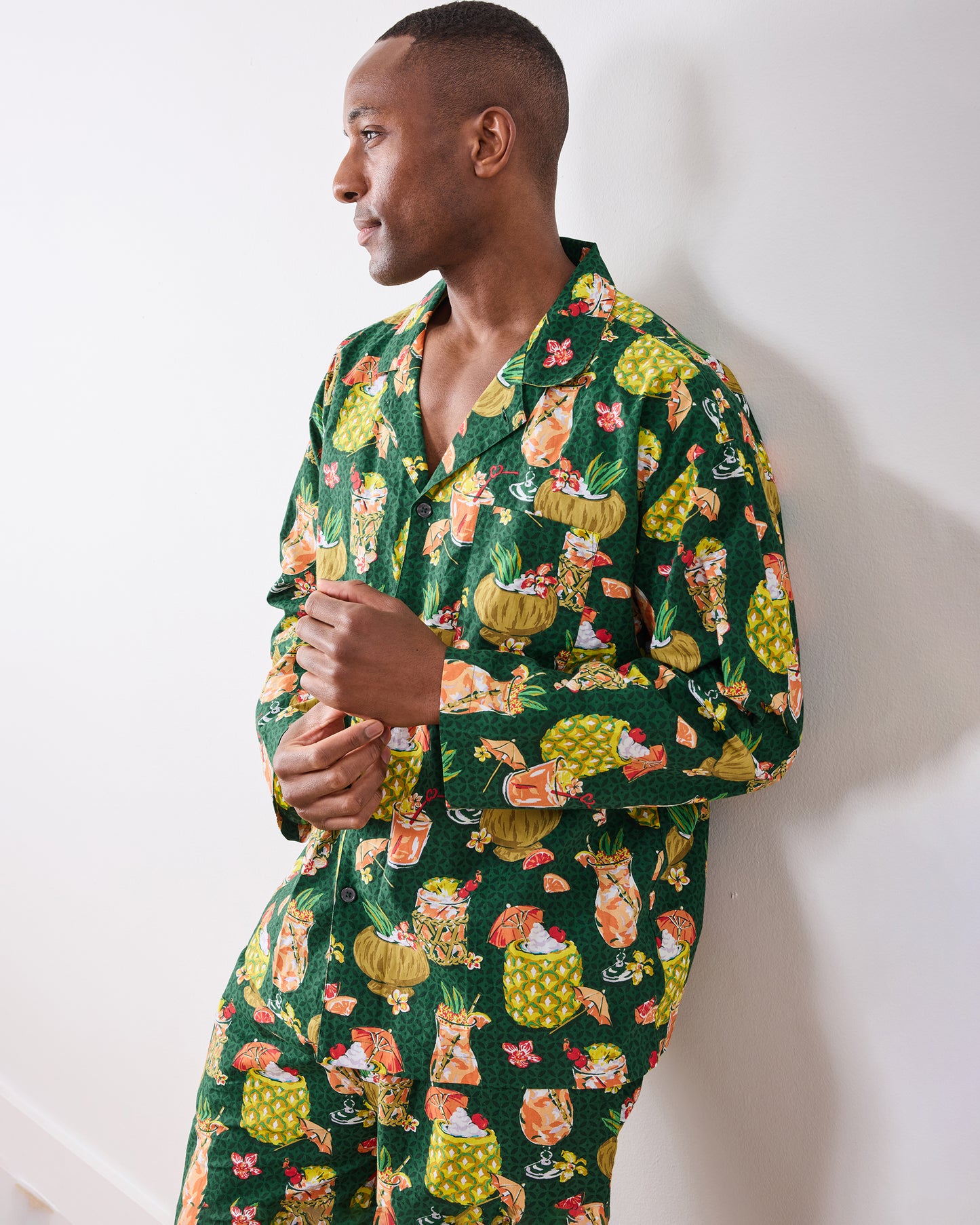 Three-quarter view of the green long pajama set with a tropical drink print