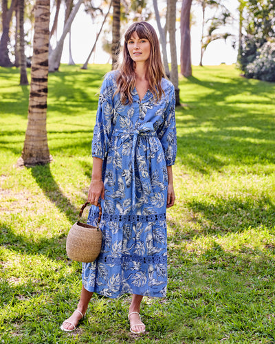 Full-length front view of the saltwater blue Monroe dress with buttoned bodice, tie belt, and lace-trimmed tiered skirt