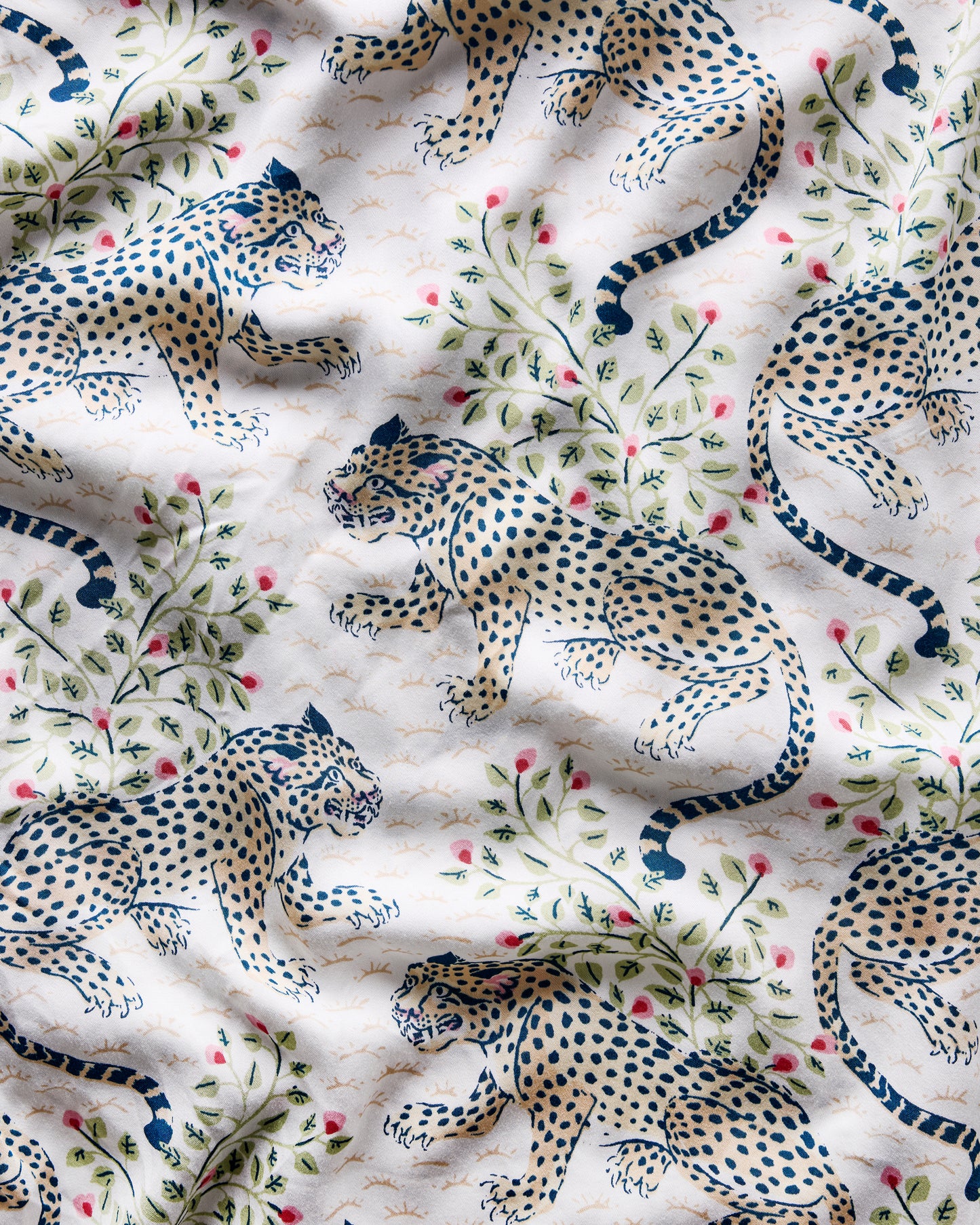 Close-up of the Wedding Cake Bagheera print with spotted leopards, leafy branches, and pink flowers on white