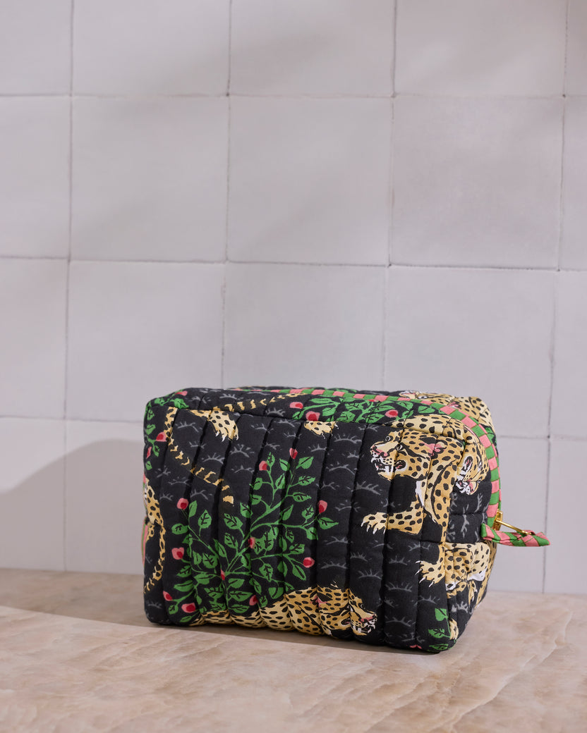 Rear angled view of the Ink Bagheera quilted pouch, showing the padded quilting and leopard-and-leaf print.