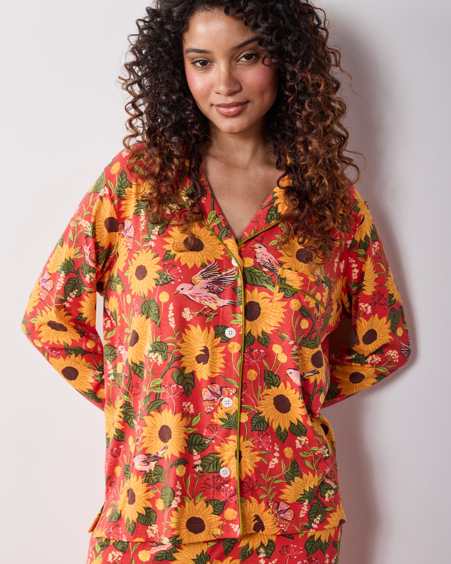 Front view of the orange Autumn Sunflowers long pajama set, showing the button-front top and matching pants.