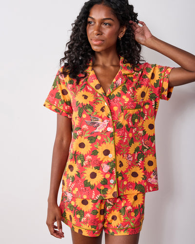 Front view of the orange Autumn Sunflowers short pajama set with a collared button-front shirt and matching shorts.