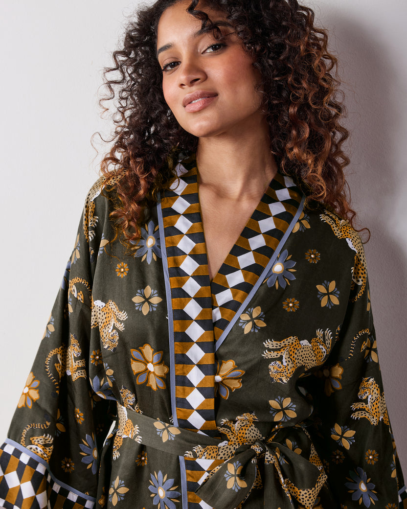 Close-up view of the olive Wrap Set showing the geometric-trimmed neckline, leopard and flower print, and waist tie.