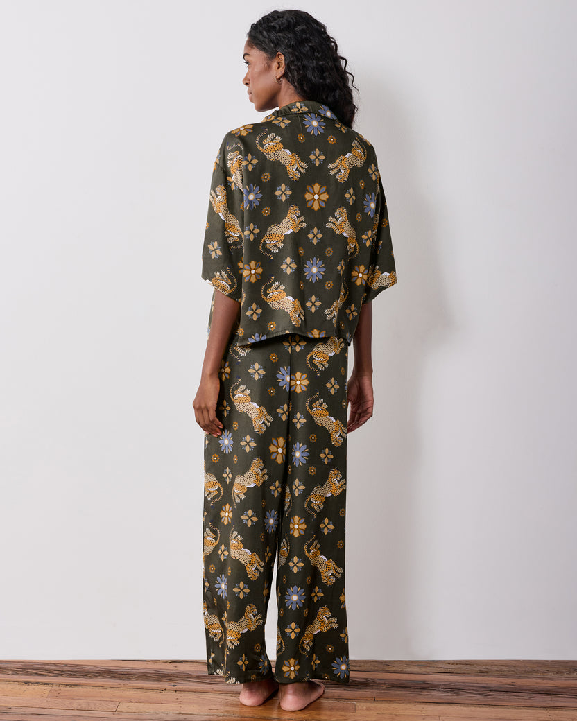 Back view of the olive Wildest Dreams pajama set, showing the short-sleeve shirt and wide-leg pants with leopard and flower prints.