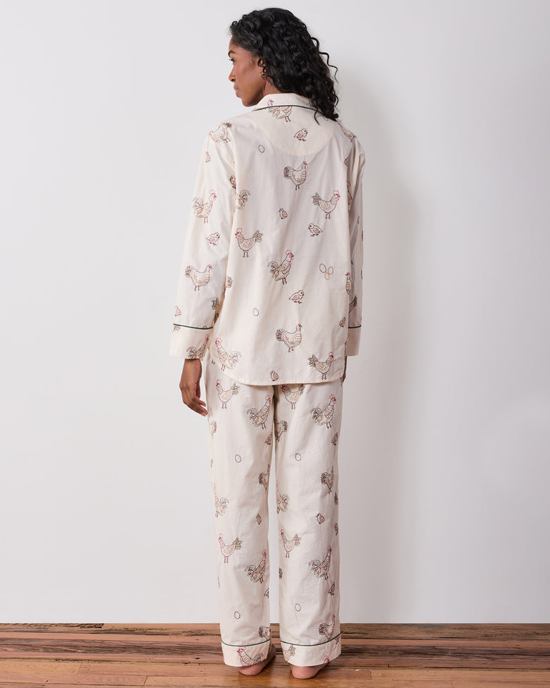 Back view of the long pajama set with embroidered hens across the button-front top and full-length pants.