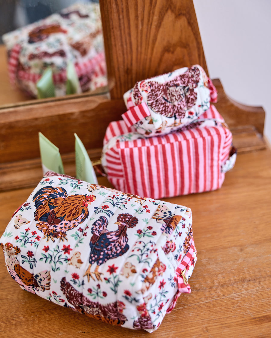 Must Love Chickens Three’s Best Pouch set displayed on a wooden surface, with one quilted pouch in front and two additional pouches behind it.