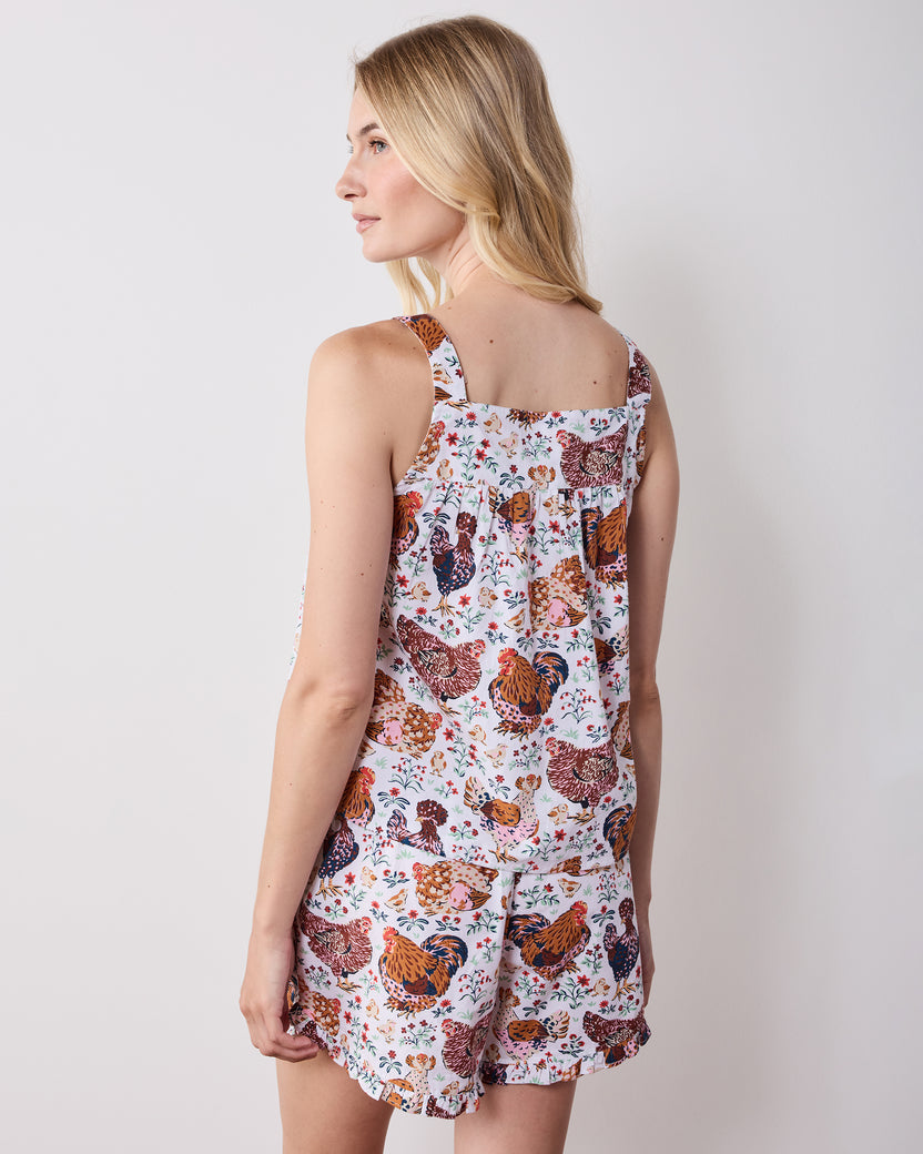 Back view of a printed short pajama set showing the camisole straps, gathered back, and matching ruffled shorts.