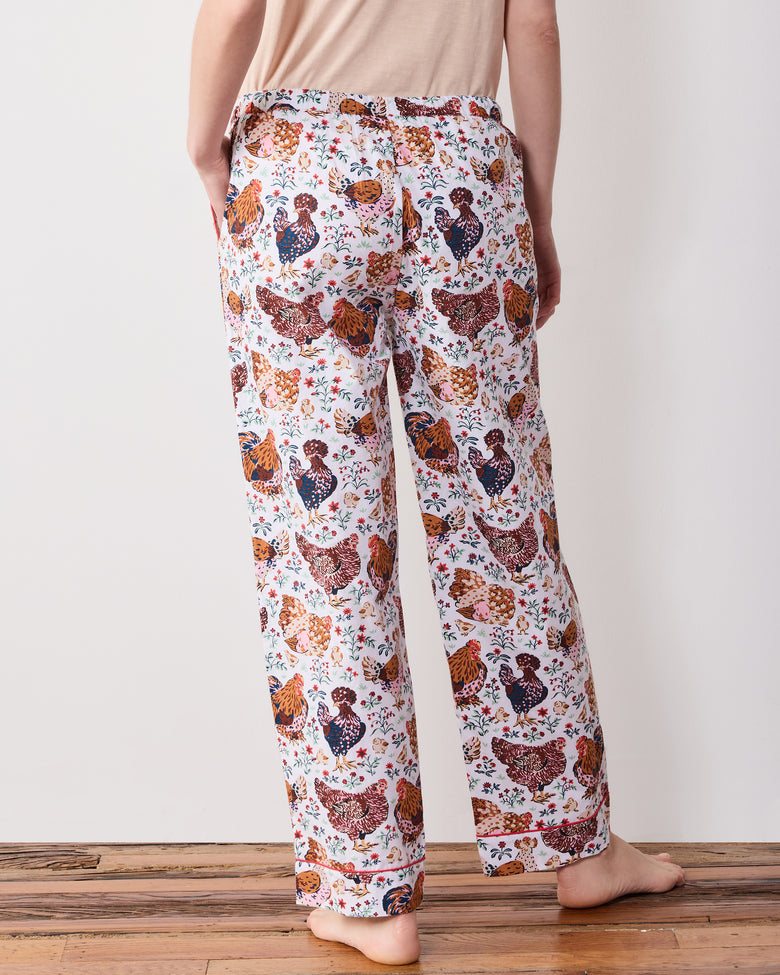 Back view close-up of printed pajama pants showing the elasticized waist, straight legs, and hem bands.