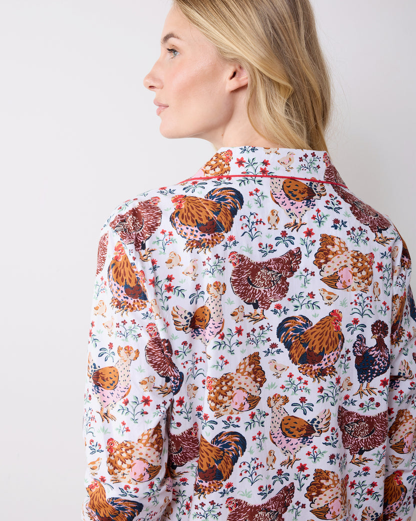 Close back view of a long-sleeve pajama top showing its chicken-and-floral print and collar.