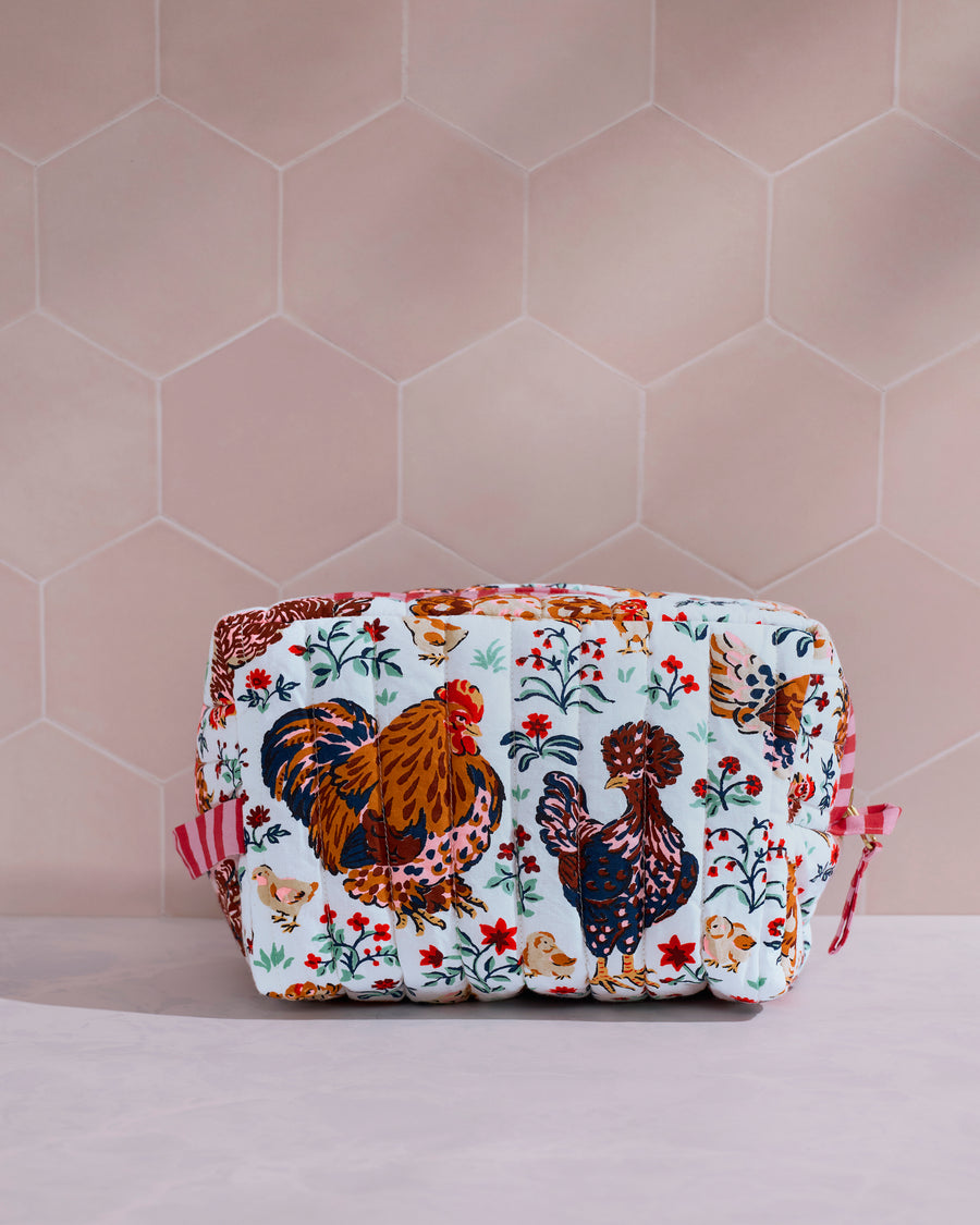 Front view of the Must Love Chickens quilted pouch, featuring two large illustrated chickens surrounded by flowers and small animals.