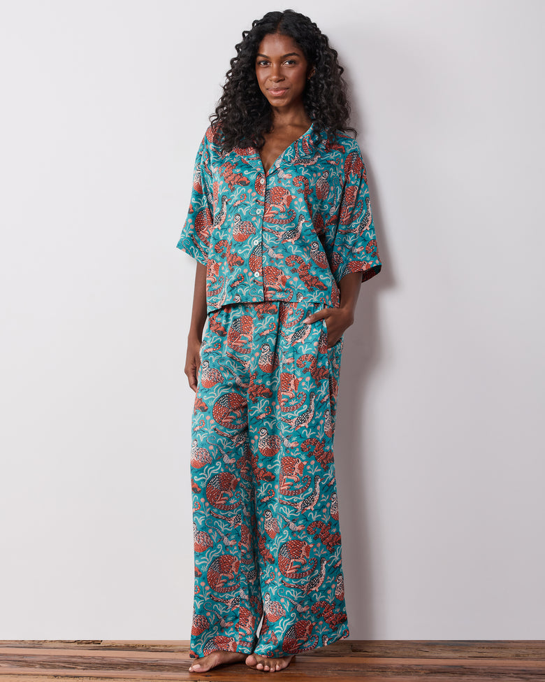 Front view of a teal patterned pajama set with a button-front top and wide-leg pants.