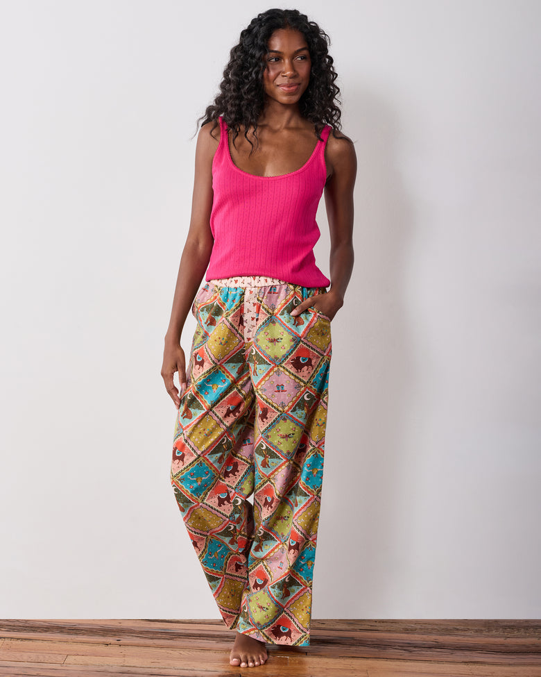 Front view of the Western Scenes wide-leg pajama pants worn with a pink tank top, showing the colorful animal and western-themed print.