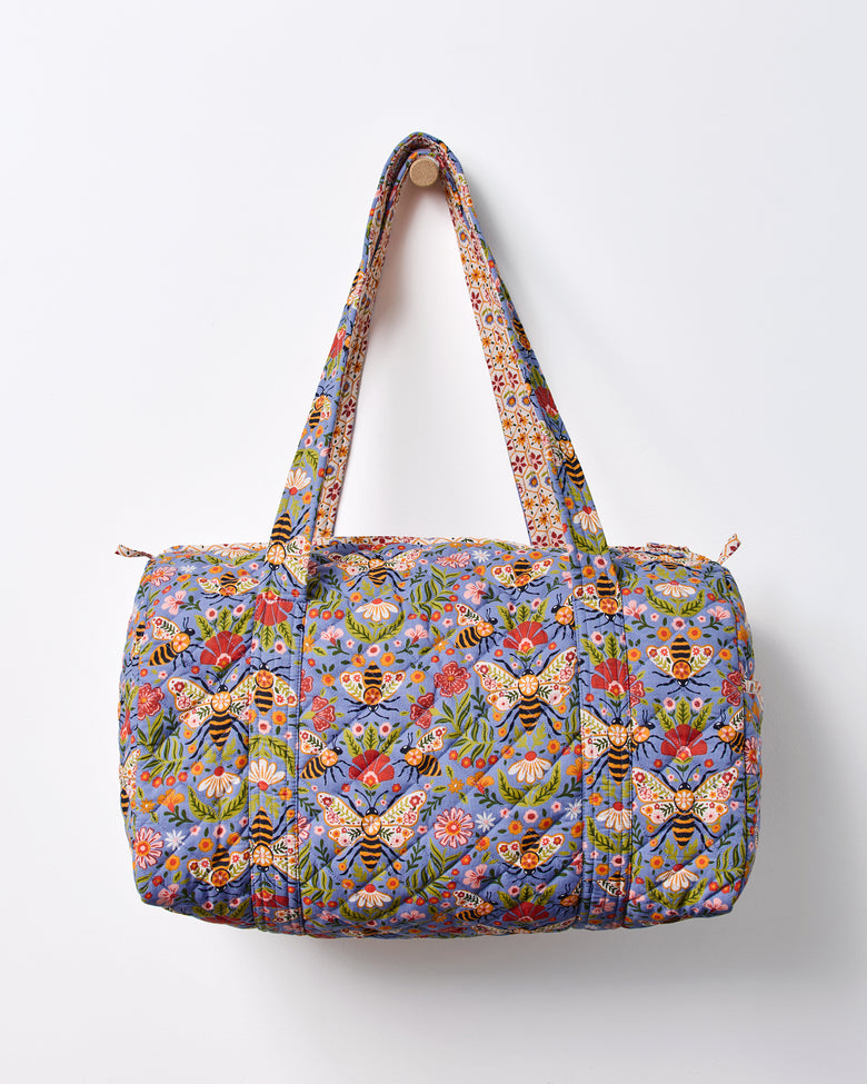 Blue Bee Tapestry quilted duffle bag shown front-facing with two handles and a top zipper.