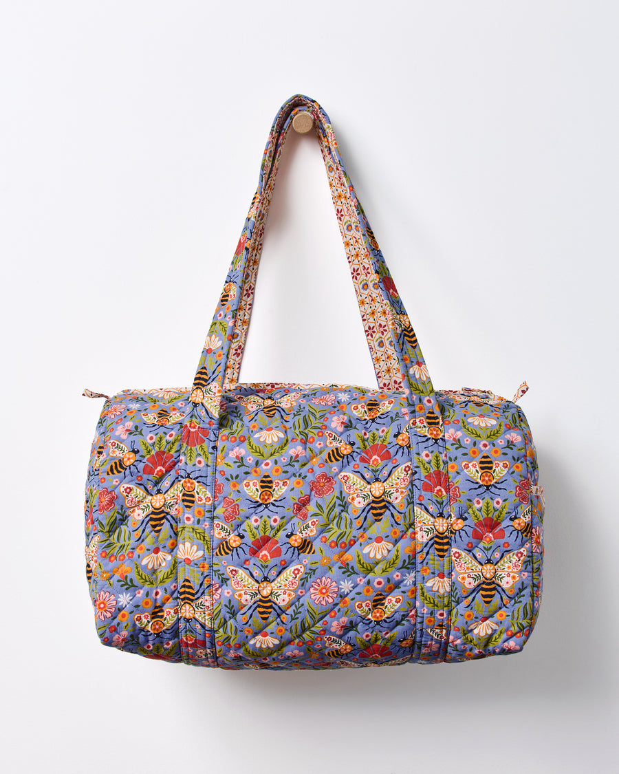 Blue Bee Tapestry quilted duffle bag shown front-facing with two handles and a top zipper.