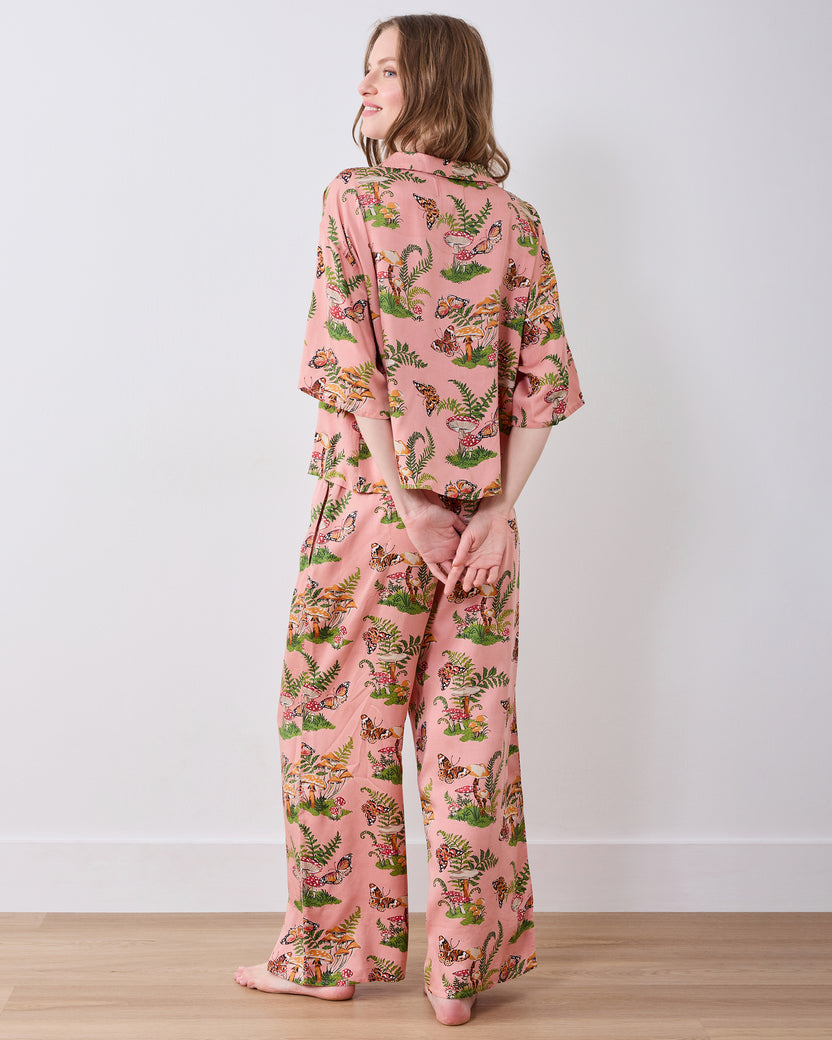 Back view of the pink Butterfly Forager tall satin Wildest Dreams pajama set with a short-sleeved top and wide-leg pants.