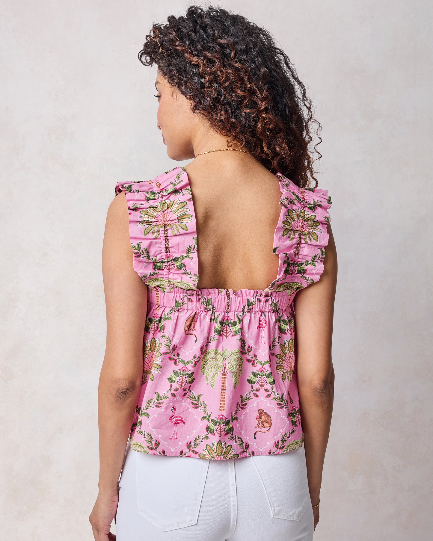 Back view of pink tropical-print Maya top with wide ruffled straps and an elastic neckline