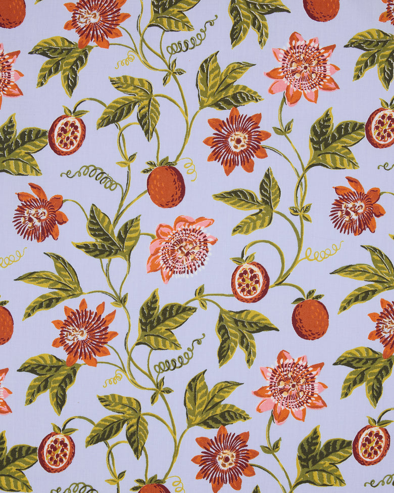 Passion Vine print swatch with orange flowers and fruit, green leaves, and curling vines on a pale blue ground