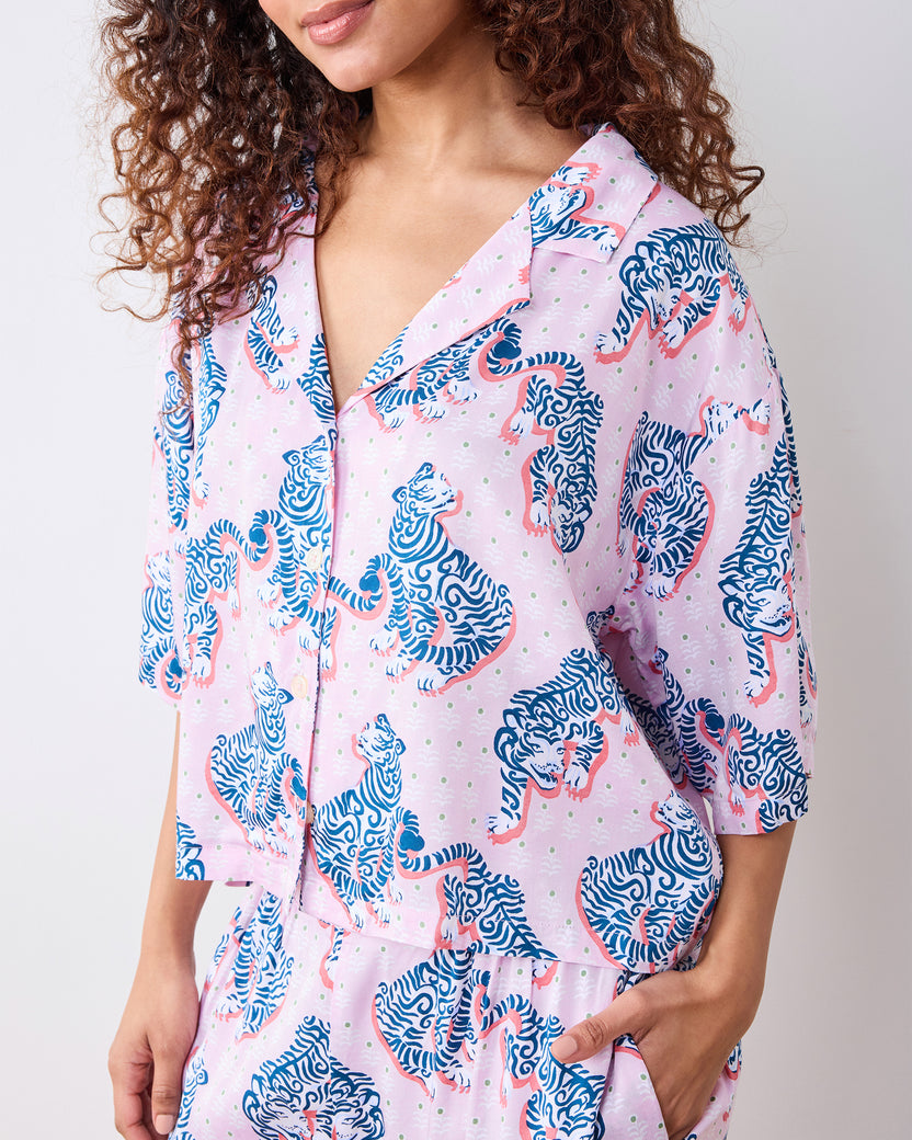 Close view of the blush pajama set with blue tiger print, three-quarter sleeves, and a pants pocket