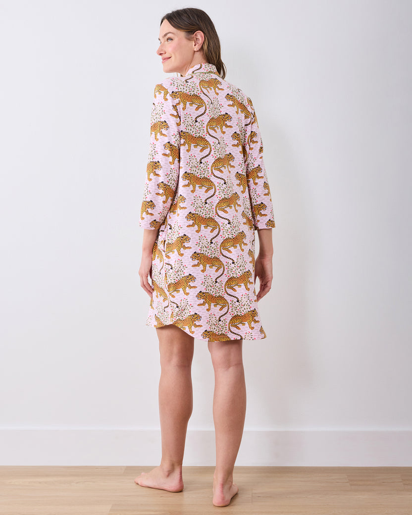 Back view of a person wearing a pink leopard-and-floral print button-front sleep shirt with three-quarter sleeves.