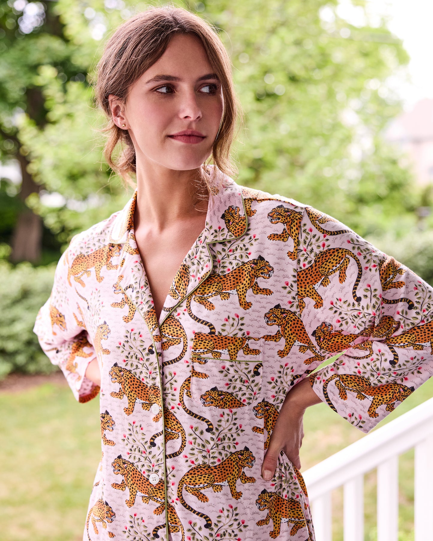 Close view of the blush Bagheera sleep shirt showing its leopard print, floral details, collar, and piping.