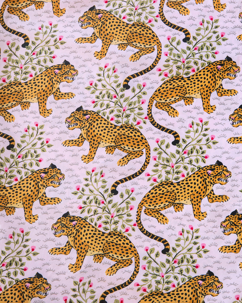 Close-up of the blush print with orange spotted cats, leafy branches, and pink buds.