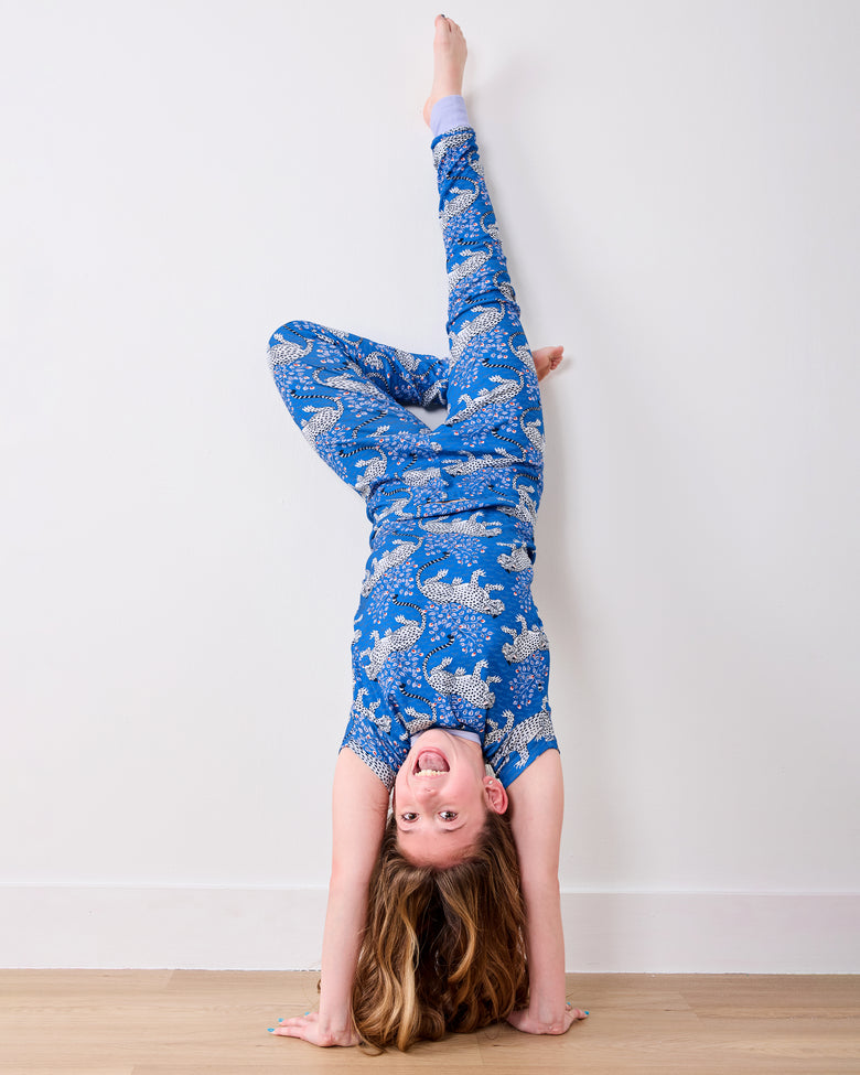 Model doing a handstand in the indigo Bagheera short-sleeve pajama set