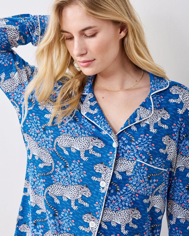 Close view of the indigo leopard-print pajama top with white piping, buttons, and chest pocket
