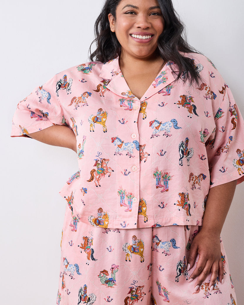 Close-up of the pink cowgirl-print petite pajama top with a notched collar, short sleeves, and front buttons.