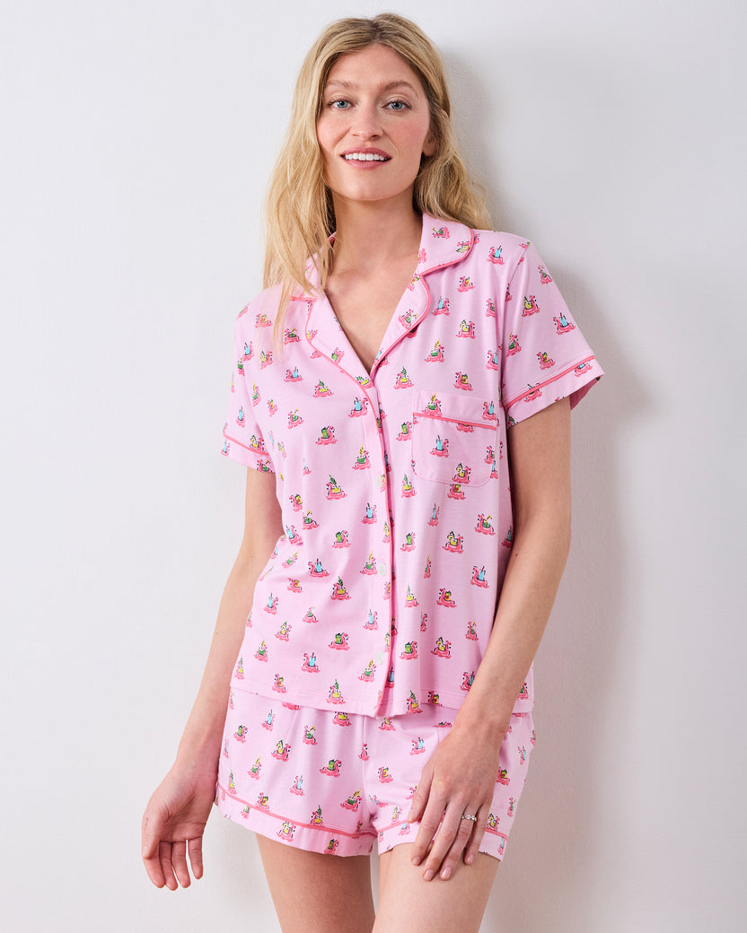Front studio view of the pink flamingo-print button-down pajama top and matching shorts