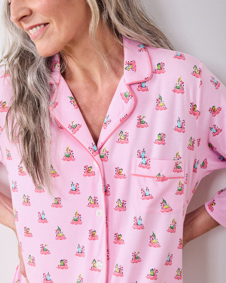 Close-up of the sleep shirt's notched collar, piping, buttons, chest pocket, and flamingo print
