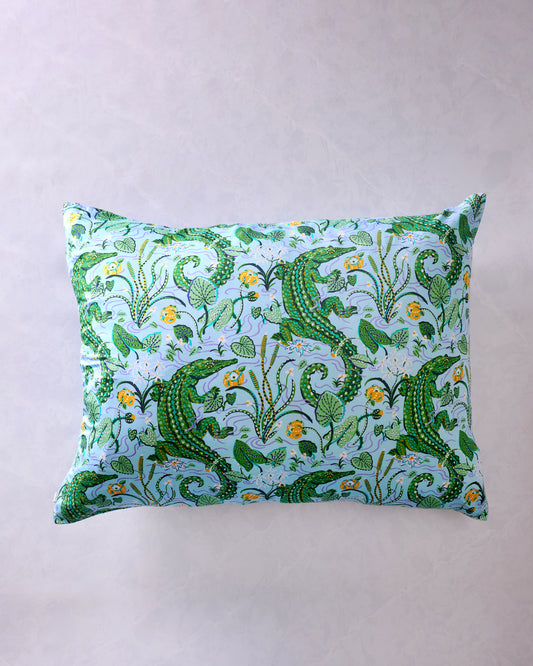 Front view of rectangular pillowcase with an alligator, foliage, and floral print