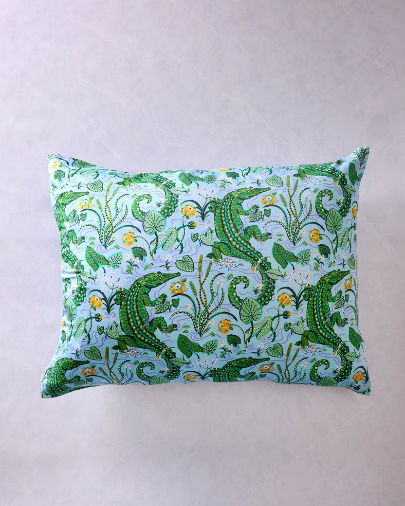 Front view of rectangular pillowcase with an alligator, foliage, and floral print