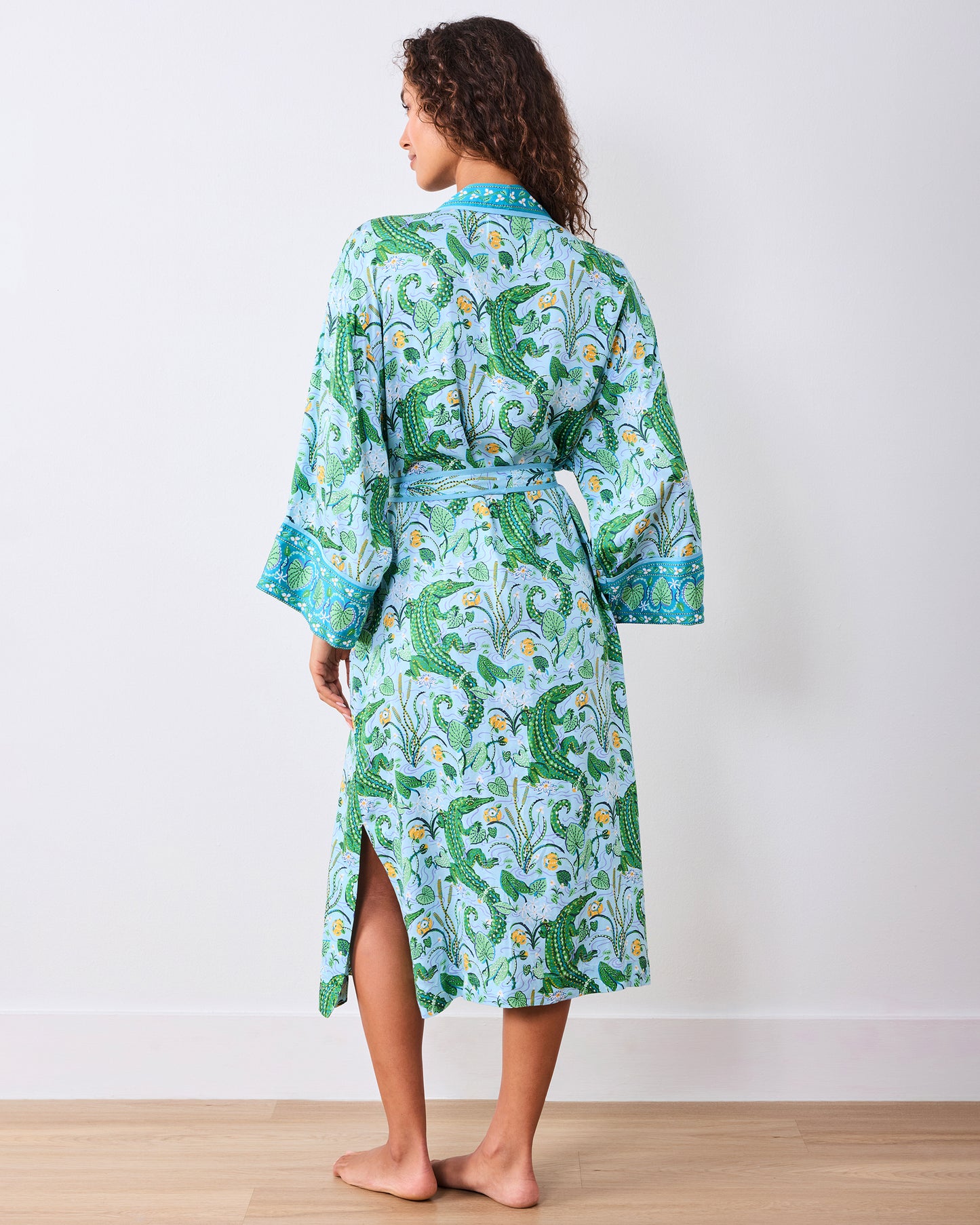 Back full-length view of the alligator-print robe with tied belt and side hem slit