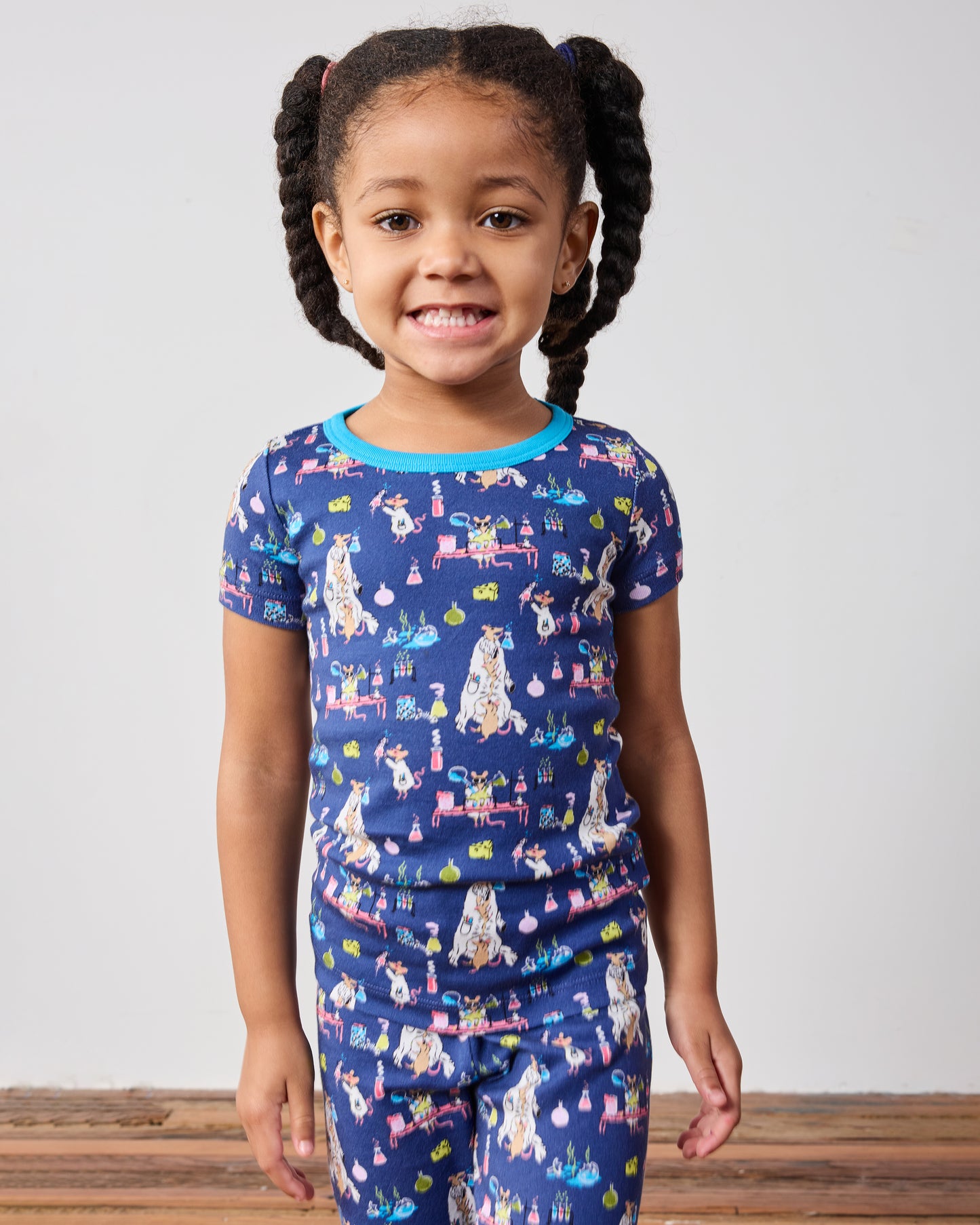 Close view of a child wearing the blue printed short-sleeve pajama top with a bright blue neckline.