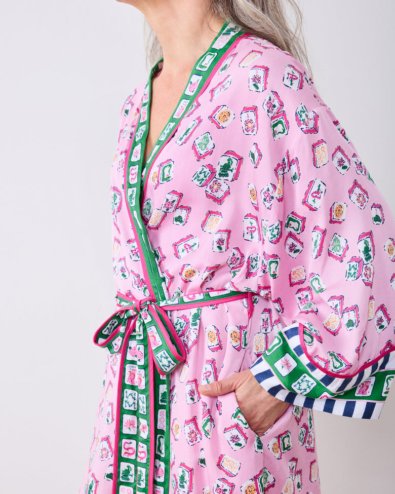 Close side view of the peony pink Lucky Tiles robe showing the tied belt, cuff trim, and pocket