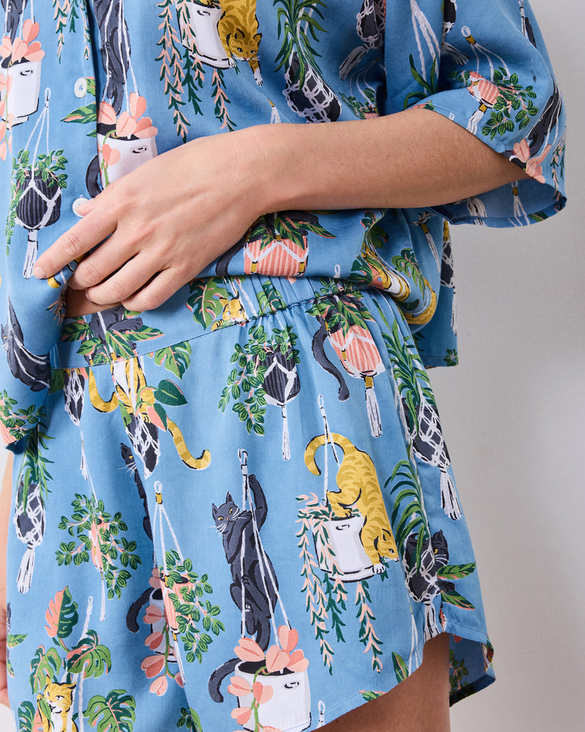 Close view of the short pajama set's elastic waistband and cats with hanging plants print