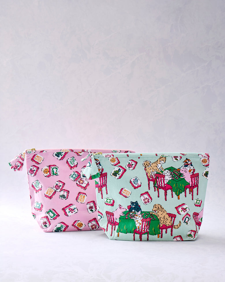 Two zip pouches, one pink with tile motifs and one mint with animals playing mah-jongg