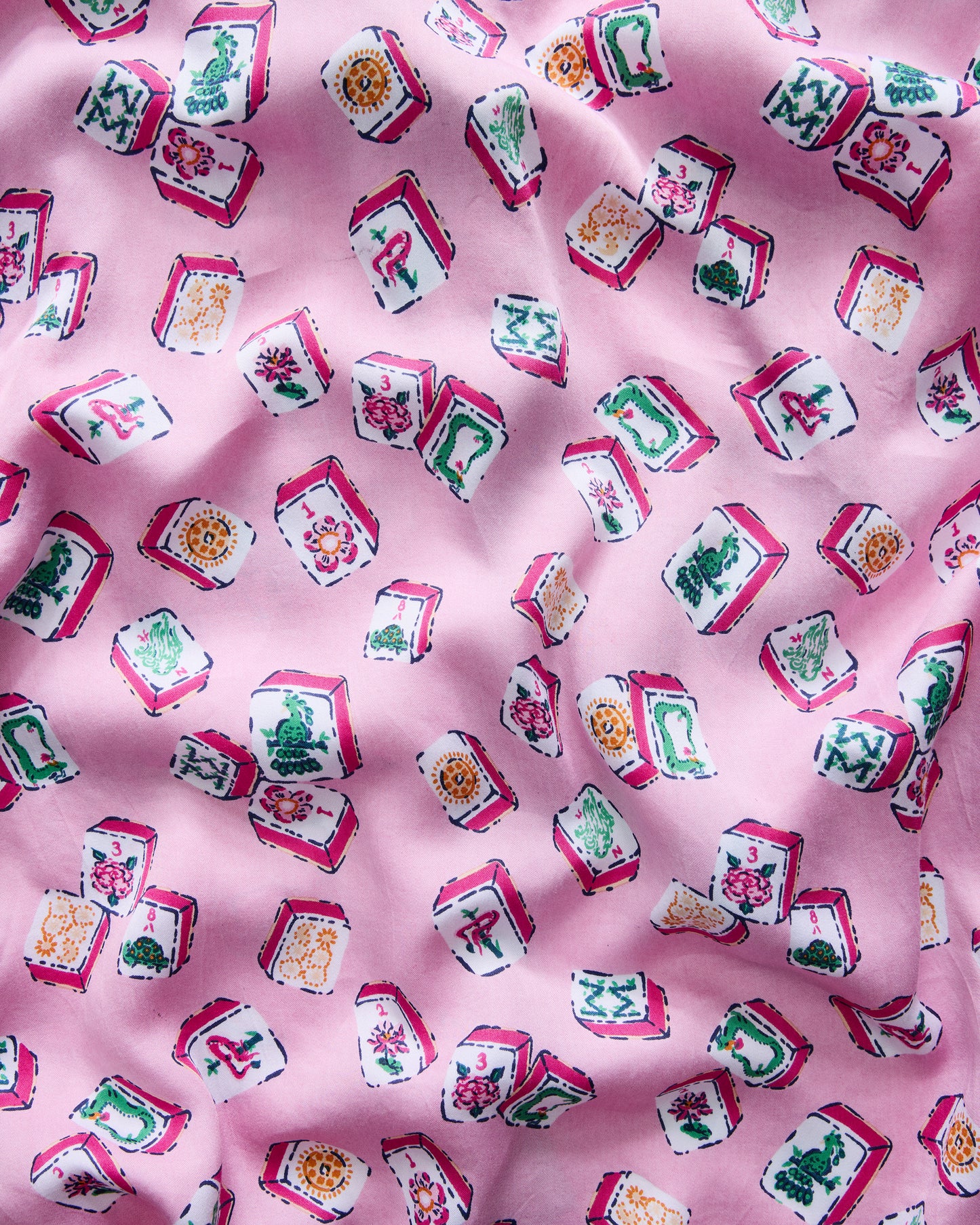 Close-up of the peony pink Lucky Tiles print on softly folded fabric