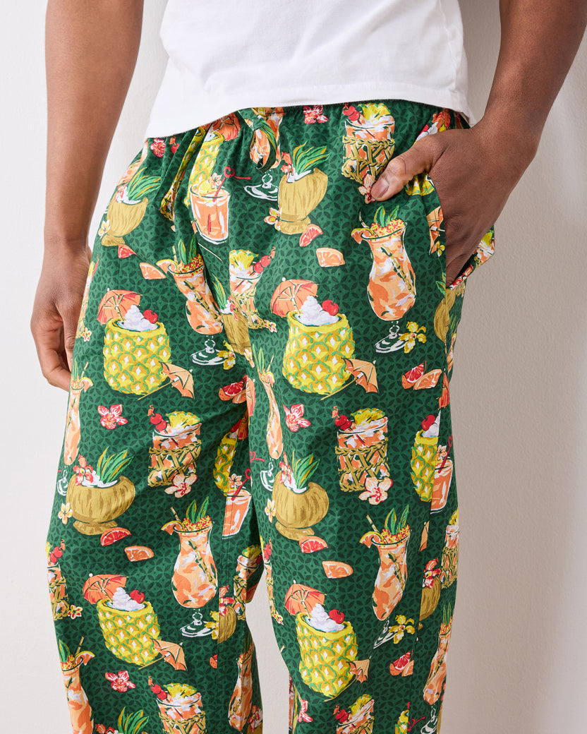 Close-up of green Paradise Punch pajama pants showing the tropical drink print and side pocket