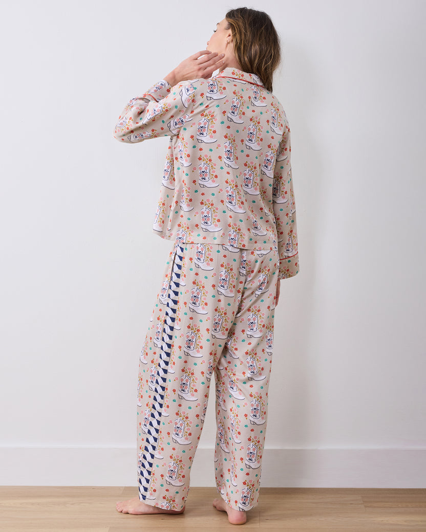 Back view of the matching long-sleeve pajama set, showing the cowboy-boot print and contrasting side panel on the pants.