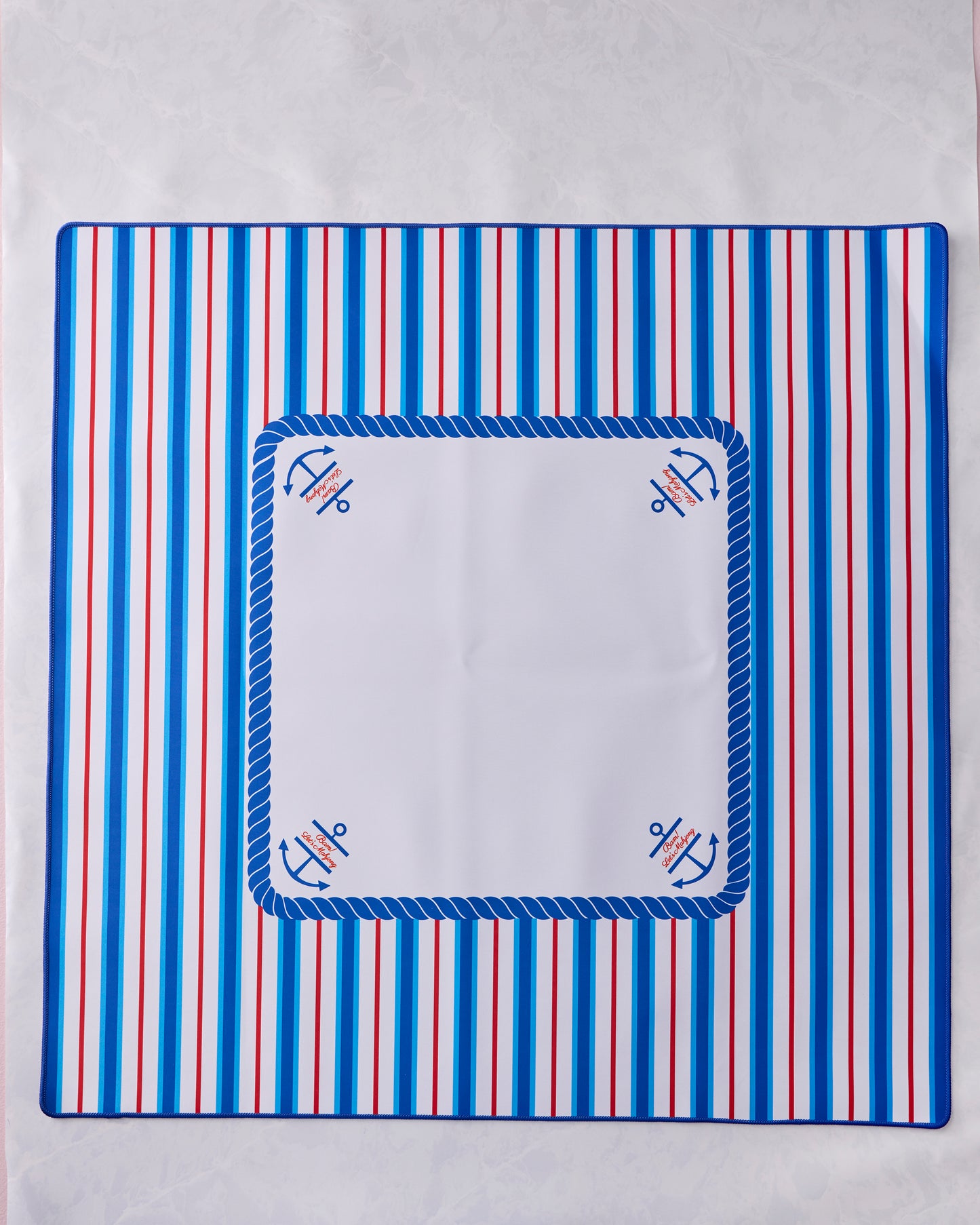 Nantucket mahjong mat with blue and red vertical stripes, a blue rope border, and anchor motifs at the corners.
