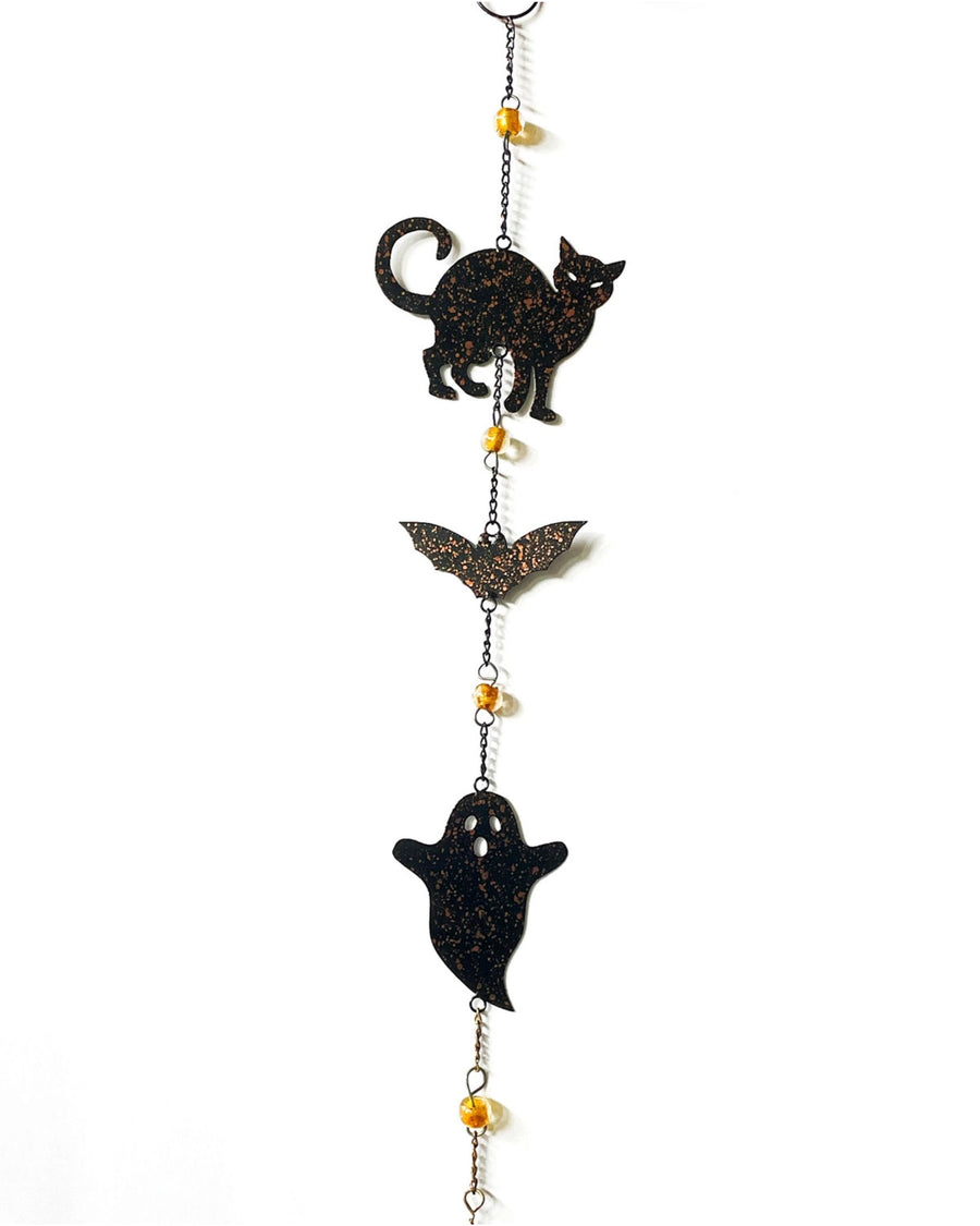 Vertical Halloween wind chime with black cat, bat, and ghost cutouts linked by chains and amber beads.