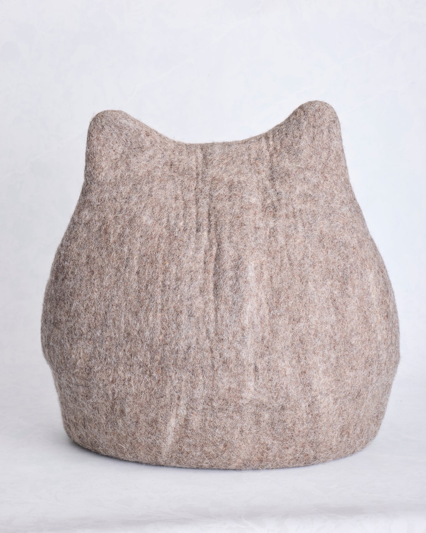 Front view of the taupe cat cave bed with pointed ears and stitched whisker details