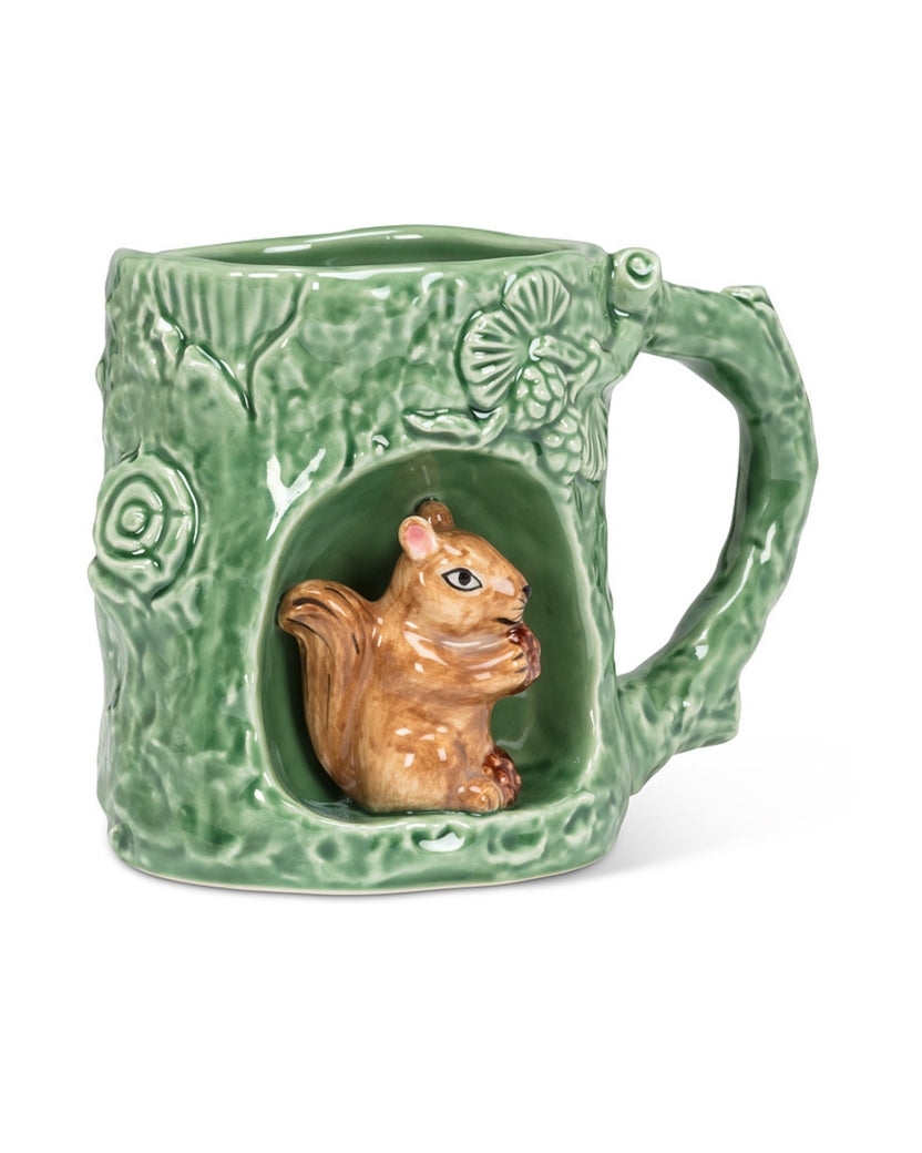 Three-quarter front view of a green mug with a squirrel figure in a recessed alcove and the handle on the right.